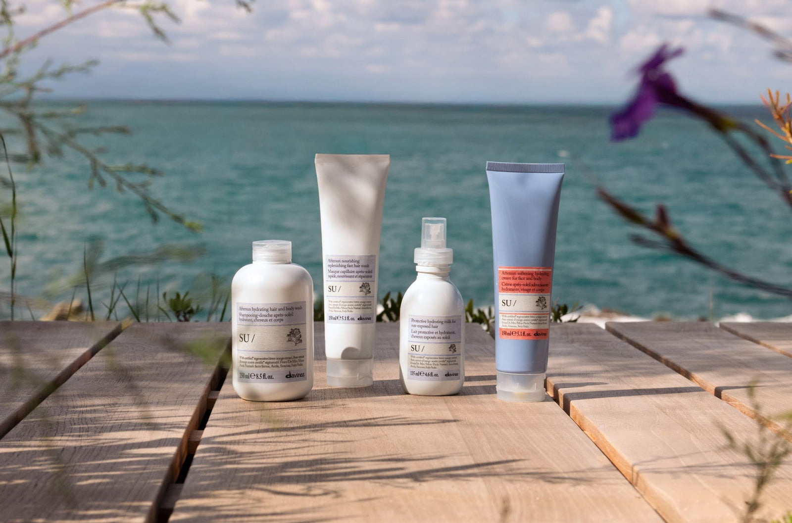 Davines SU products sitting on an ocean boardwalk