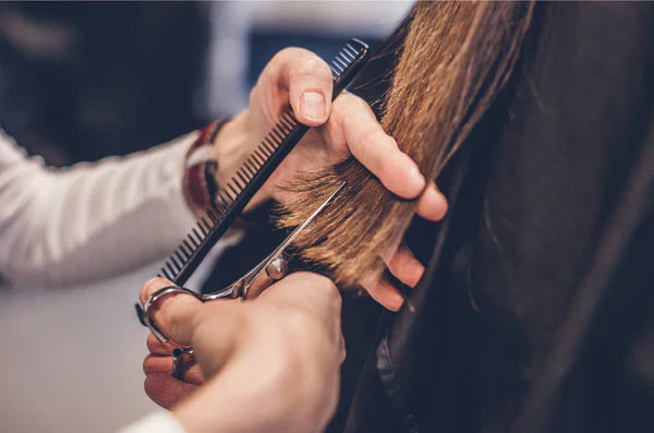 hairdresser trimming hair
