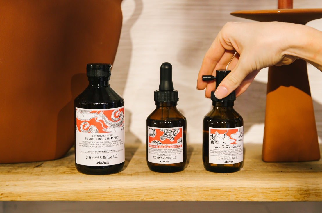 hand reaching for Davines ENERGIZING products